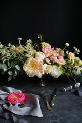 Wedding decor, Pink peony on silk napkins and flower arrangement on a dark background, Wedding bouquet, Decorator, Copy Space, Selective focus