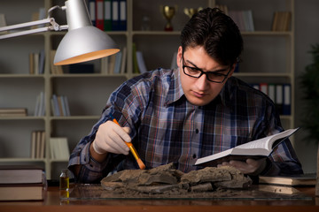 Archeologist working late night in office