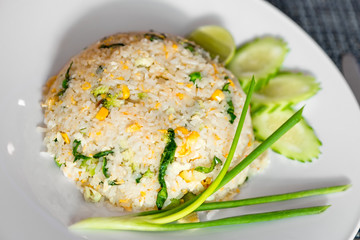 A portion of rice cooked in a Thai recipe with vegetables and eggs close-up on a plate