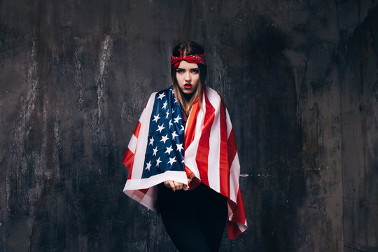 Girl dressed in USA flag on dark background. American patriot, national event celebration, pride, usa citizen concept