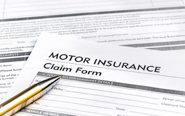 Pen on motor insurance claim form.