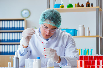 Young doctor working on blood test in lab hospital