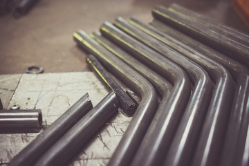 Steel pipe on a work bench. - obrazy, fototapety, plakaty
