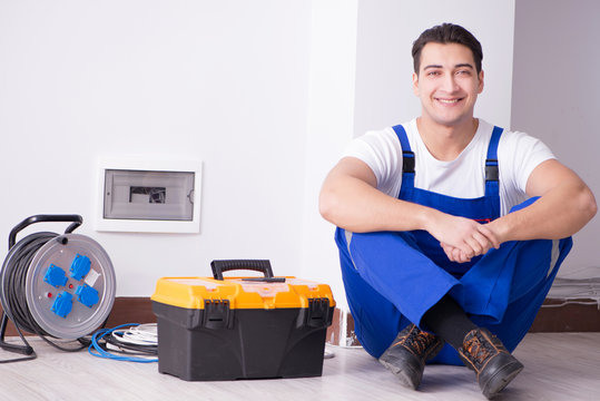 Young Electrician Working On Socket At Home