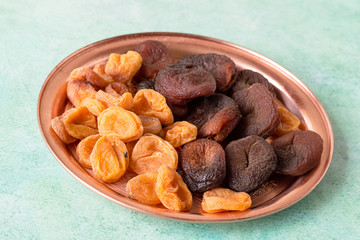  Dried fruits. Natural dried apricots on a round copper tray,
