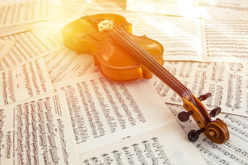 Old violin lying on the sheet of music