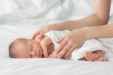 Newborn baby. Mother gently strokes her child's hand - 159212128
