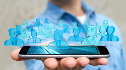 Businessman holding 3D rendering group of blue people
