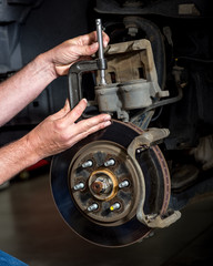 Master mechanic replaces disc brakes on a pickup