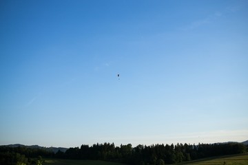 Paraglider and balloon flying in the air during colorful sunset. Slovakia