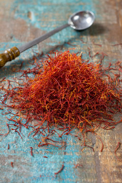 Dried organic red saffron Spice on wooden background