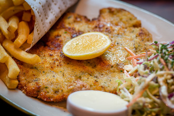 German schnitzel pork chop woth fries and apple coleslaw