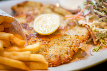 German schnitzel pork chop woth fries and apple coleslaw