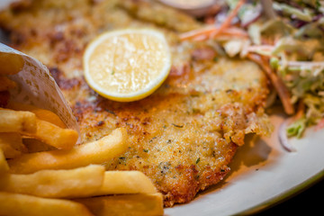 German schnitzel pork chop woth fries and apple coleslaw