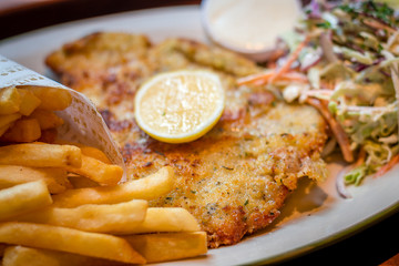 German schnitzel pork chop woth fries and apple coleslaw