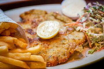 German schnitzel pork chop woth fries and apple coleslaw