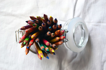 Bank with multi-colored watercolor pencils