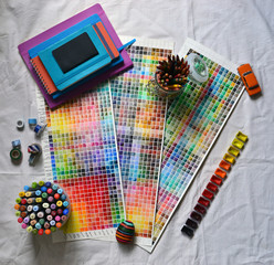 A composition of artistic accessories and a watercolor palette