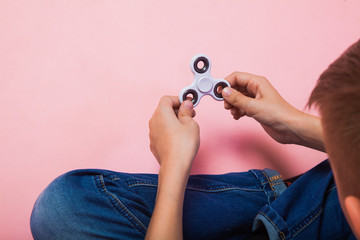 Teen boy with popular toy fidget spinner