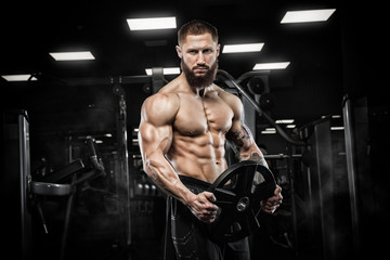 Obraz na płótnie Canvas Attractive tall muscular bodybuilder doing heavy deadlifts in moder fitness center.