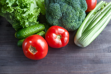  Fresh vegetables on the table. Cucumbers, tomatoes, lettuce, Celery, broccoli.  Stylish, juicy background of fresh vegetables.