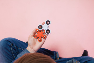 Teen boy with popular toy fidget spinner