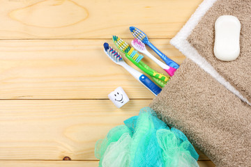 toothbrush tooth-brush with soap, bath towel and wisp of bast on wood background