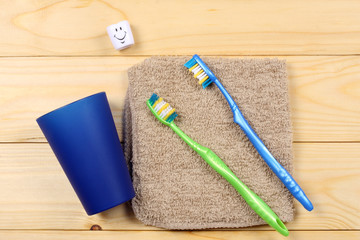 toothbrush tooth-brush with soap, bath towel and wisp of bast on wood background