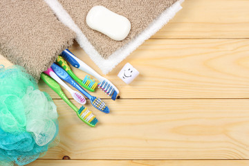 Obraz na płótnie Canvas toothbrush tooth-brush with soap, bath towel and wisp of bast on wood background