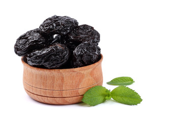 Dried plums - prunes in wooden bowl isolated on white background