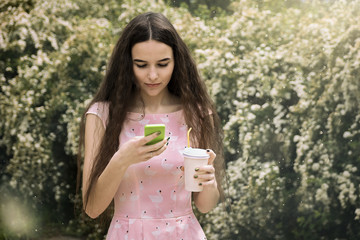 young pretty brunette woman eat chocolate, using smartphone