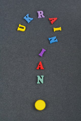 UKRAINIAN word on black board background composed from colorful abc alphabet block wooden letters, copy space for ad text. Learning english concept.