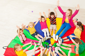 Happy teacher playing circle games with children