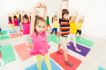 Sporty kids stretching during gymnastic activity