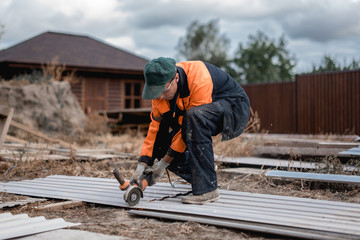 Young construction worker outdoors. Renovation background.