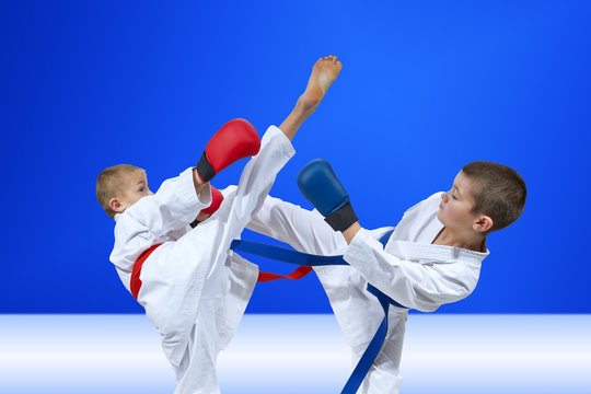 Sportsmen are beating kicks on a light blue background