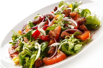 Salad with smoked ham on white background 