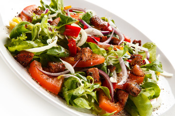 Salad with smoked ham on white background 
