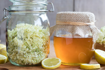 A jar of honey and elder flowers, ready to make a syrup