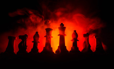 chess board game concept of business ideas and competition and strategy ideas concep. Chess figures on a dark background with smoke and fog