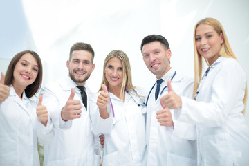 Fototapeta premium Happy doctors smiling and showing thumbs up.