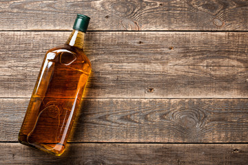 Bottle of whiskey on wooden boards
