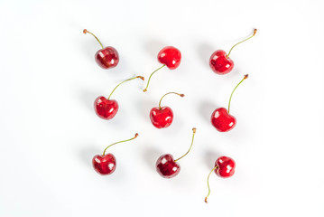 Fototapeta na wymiar Fresh raw organic seasonal fruits. The seamless pattern, cherries on a white background. Top view copy space