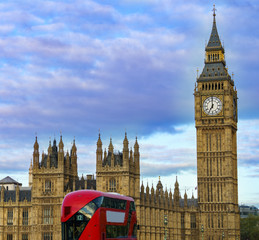 Panoramic view of Big Ben and Westminster parliament in London, United Kingdom at sunrise with double decker London bus on the foreground.