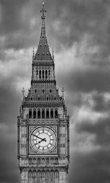 Close up of the clock face of Big Ben in Westminster, London on a cloudy day. Black and white picture with dramatic sky.