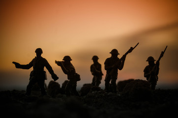 War Concept. Military silhouettes fighting scene on war fog sky background, World War Soldiers Silhouettes Below Cloudy Skyline At night. Attack scene. Armored vehicles. Tanks battle