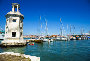 A view on San Giorgio Maggiore Island's lighthouse with yachting harbour in the background, Venice, Italy