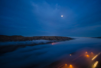 Fototapeta na wymiar fog in the morning with mountain and moon at Baku, Azerbaijan