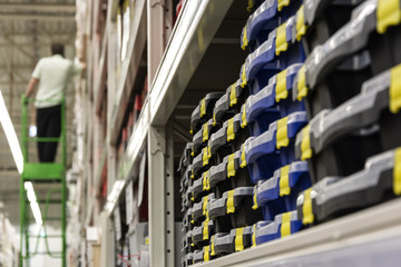 A man stands on a ladder in the shop building tools