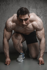 Obraz premium Brutal strong athletic men pumping up muscles